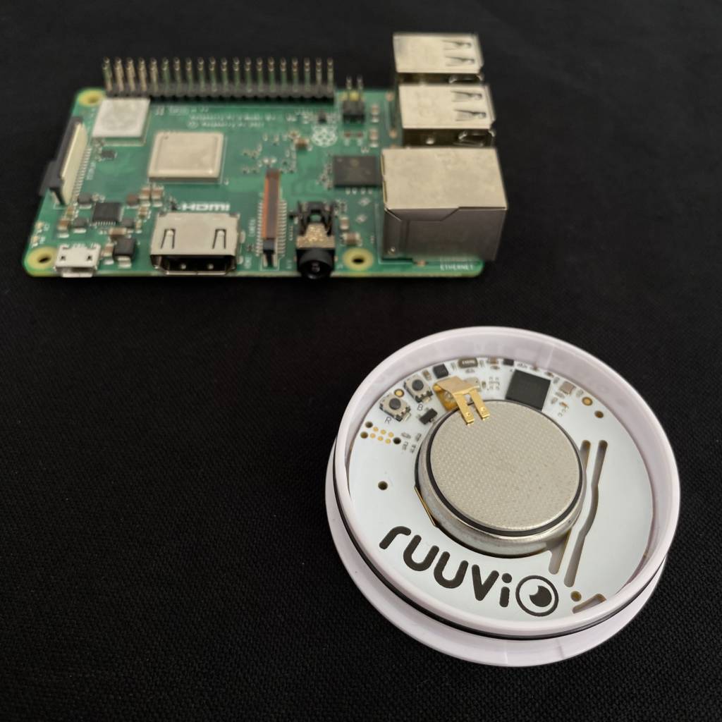 RuuviTag next to Raspberry Pi. Both devices are open source and they work well together.