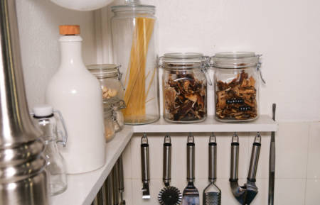 Glass jars filled up with dried food. Drying food lets you to enjoy hand picked food during cold winter